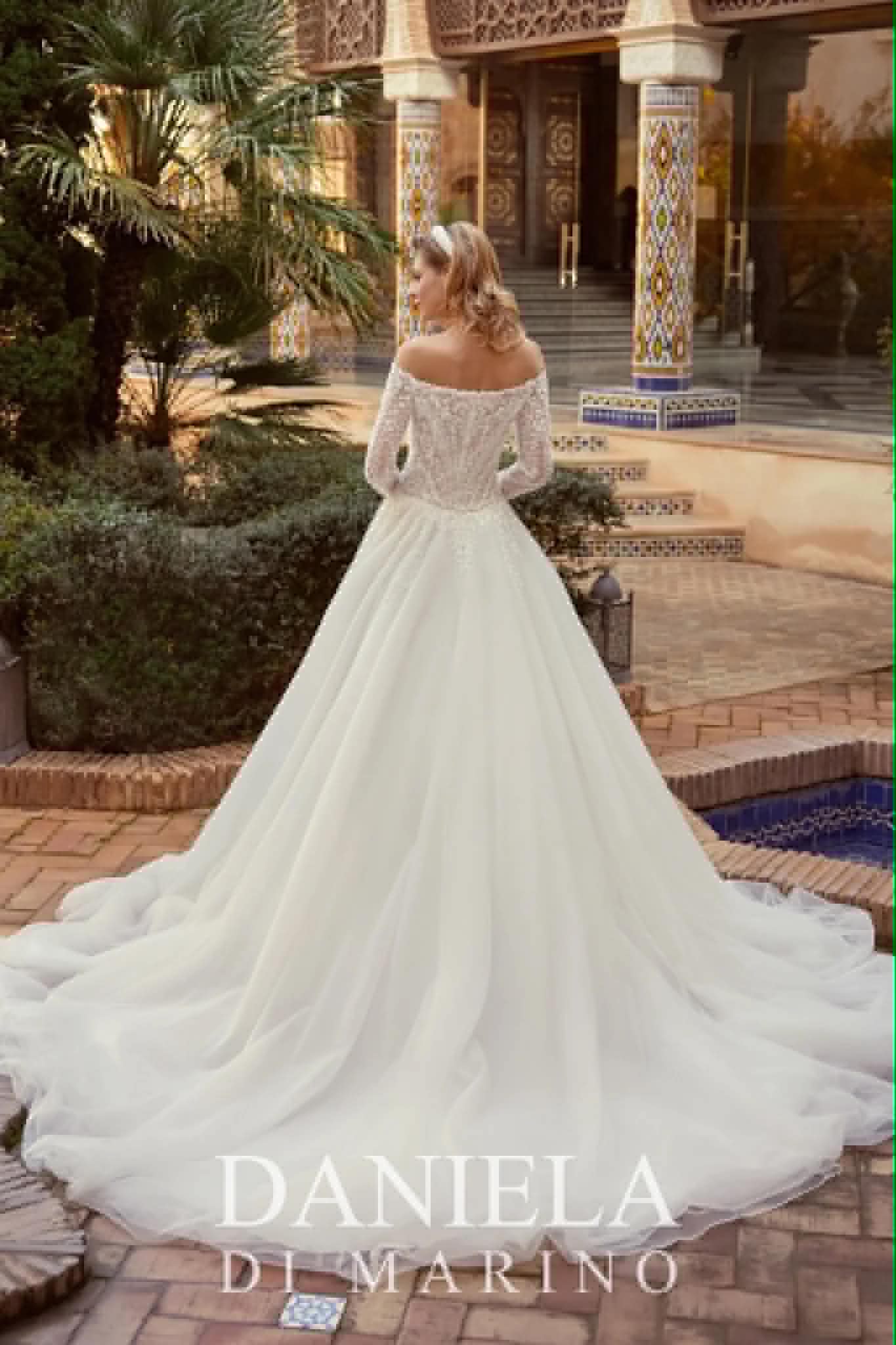 Bardot off-shoulder long-sleeve lace gown with a full skirt — back view