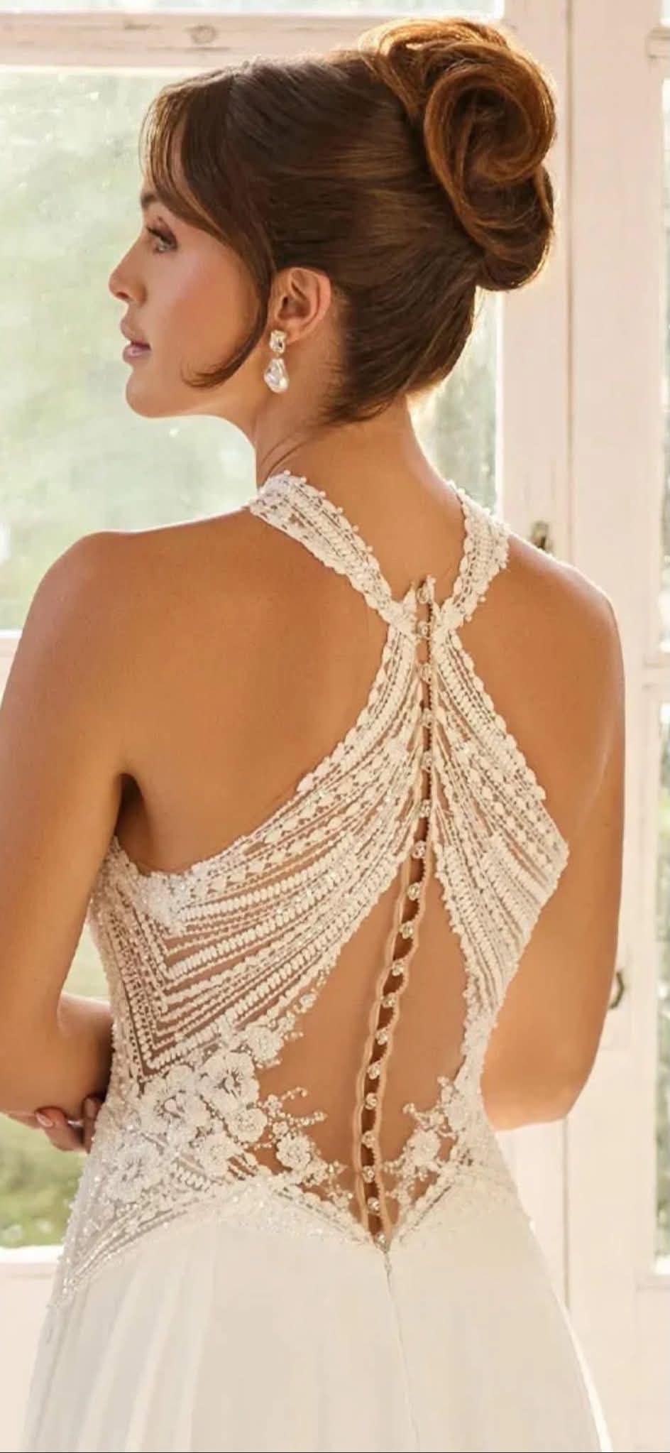 Halter-neck beaded-bodice gown with a flowing skirt — back view