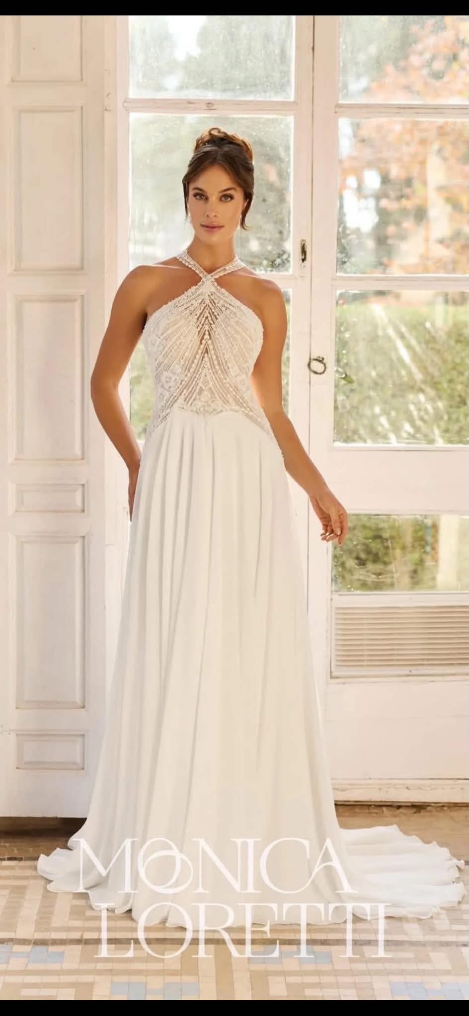 Halter-neck beaded-bodice gown with a flowing skirt