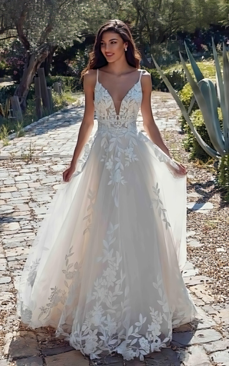 Bride in a floral-lace gown in a sunlit garden